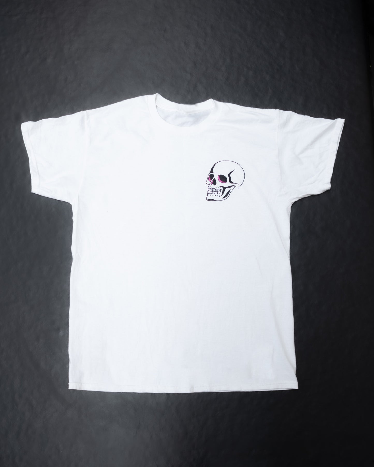 White t-shirt with a skull design on a dark textured background