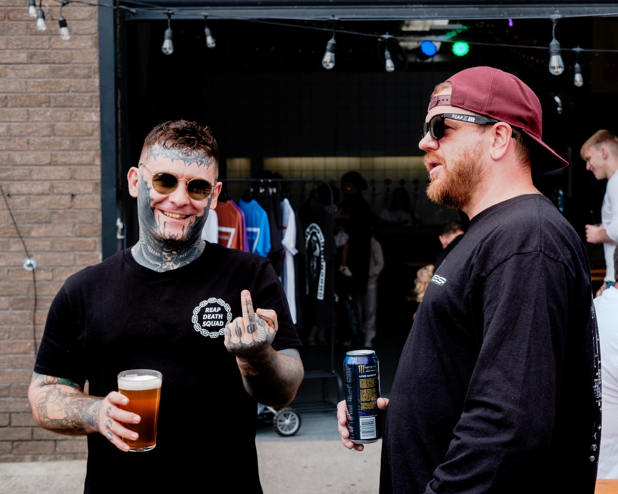 Man wearing death squad tee holding a pint of beer 