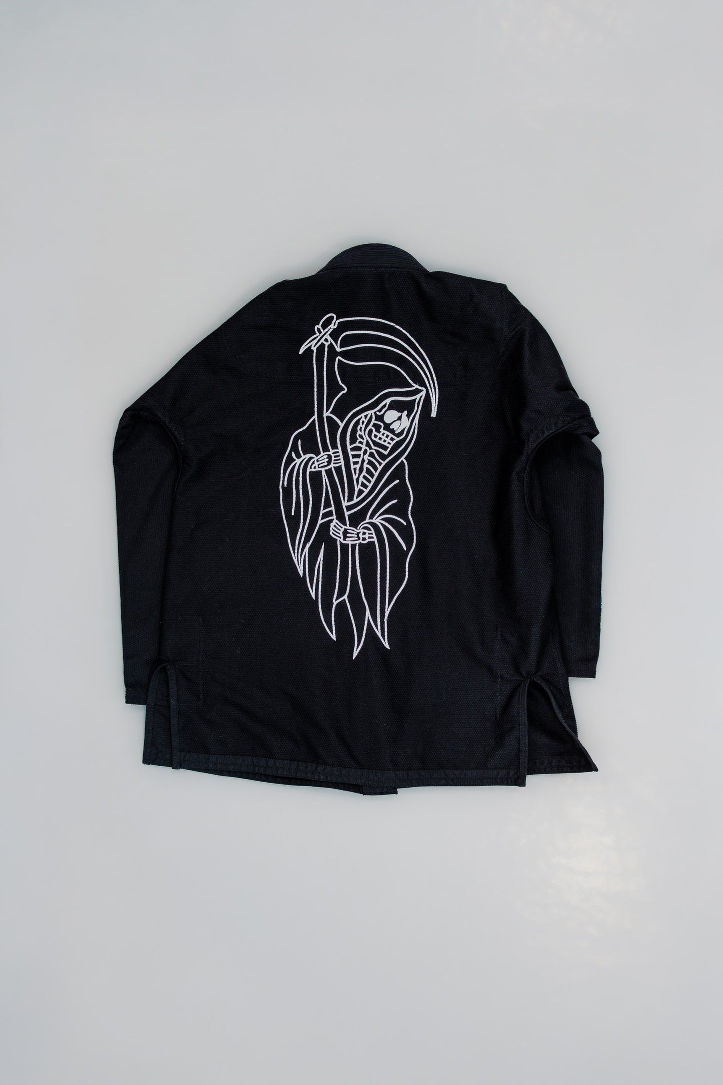 Black jacket with white graphic design on a light gray background