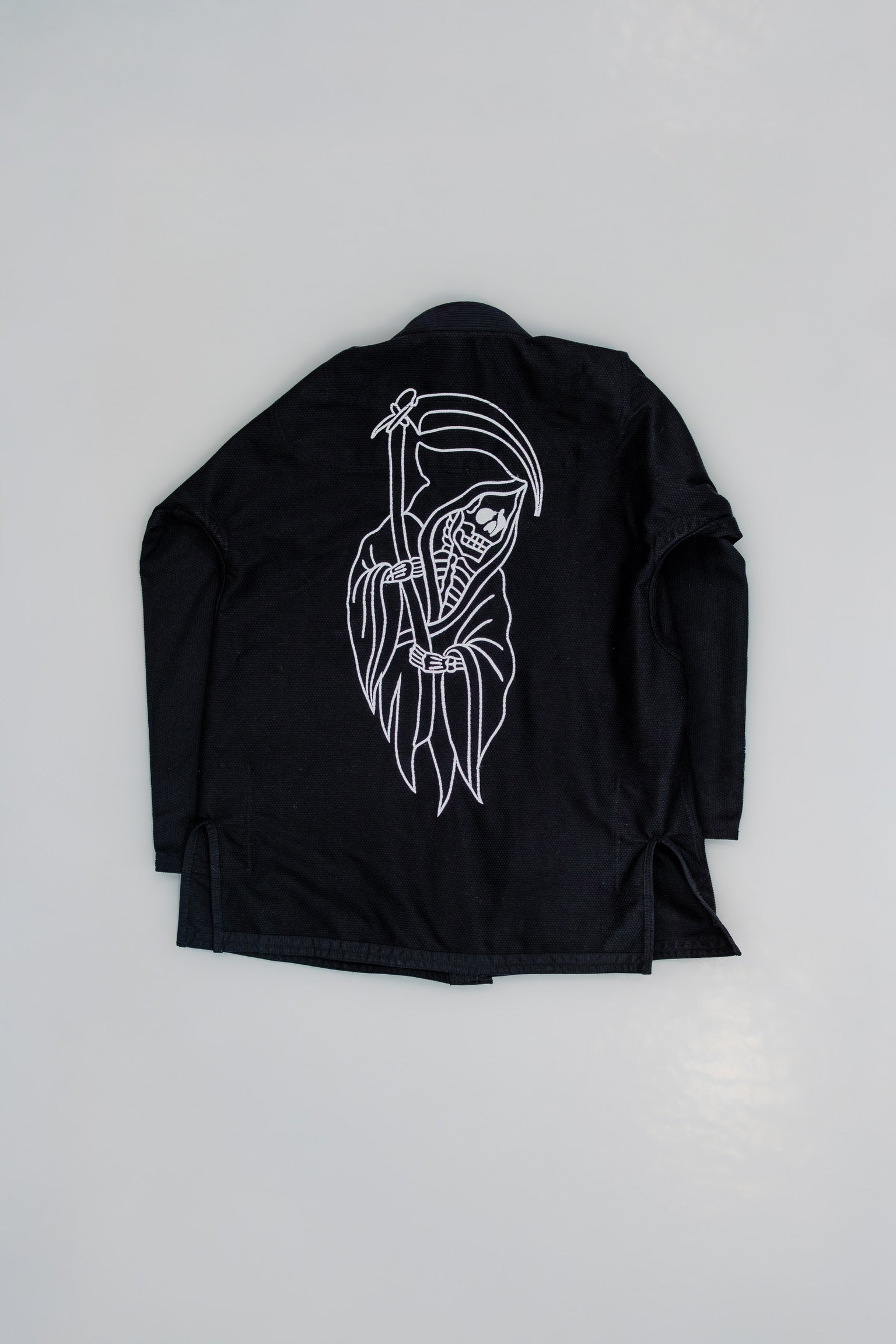 Black jacket with white graphic design on a light gray background