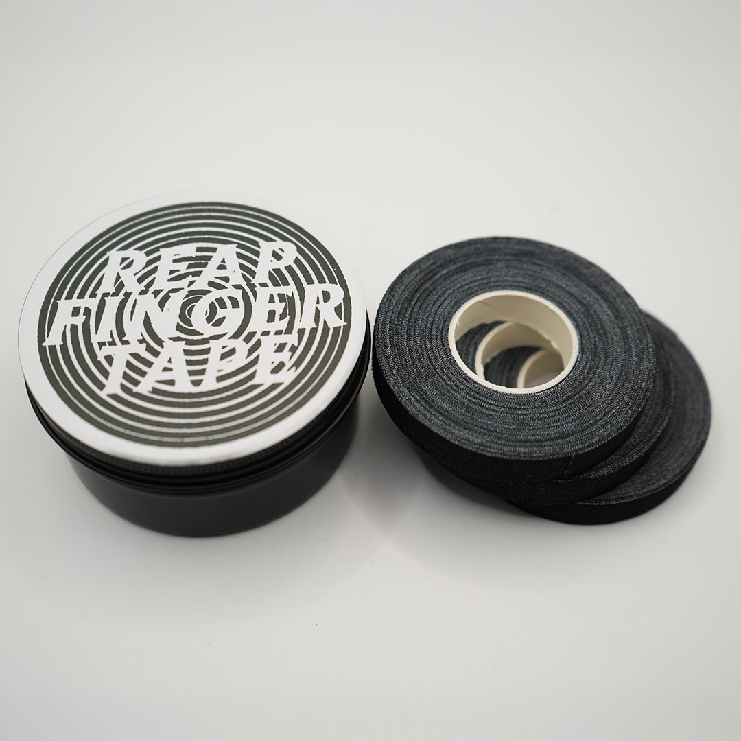 A stack of 3 rolls of black Jiu Jitsu finger tape