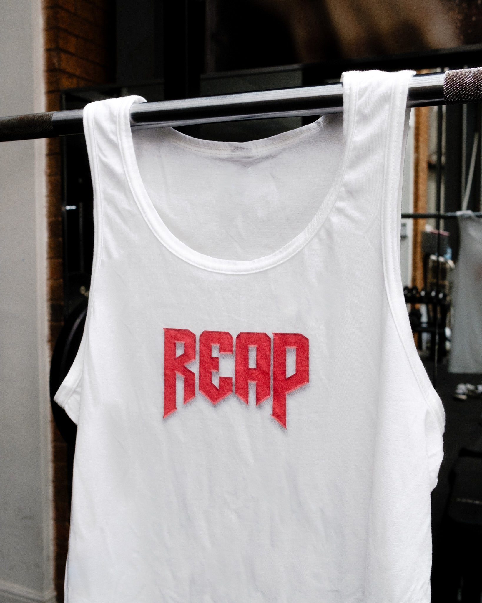White Jiu Jitsu workout vest from Reap Jiu Jitsu, featuring a sleek design for active individuals. Ideal for martial arts training and fitness activities.
