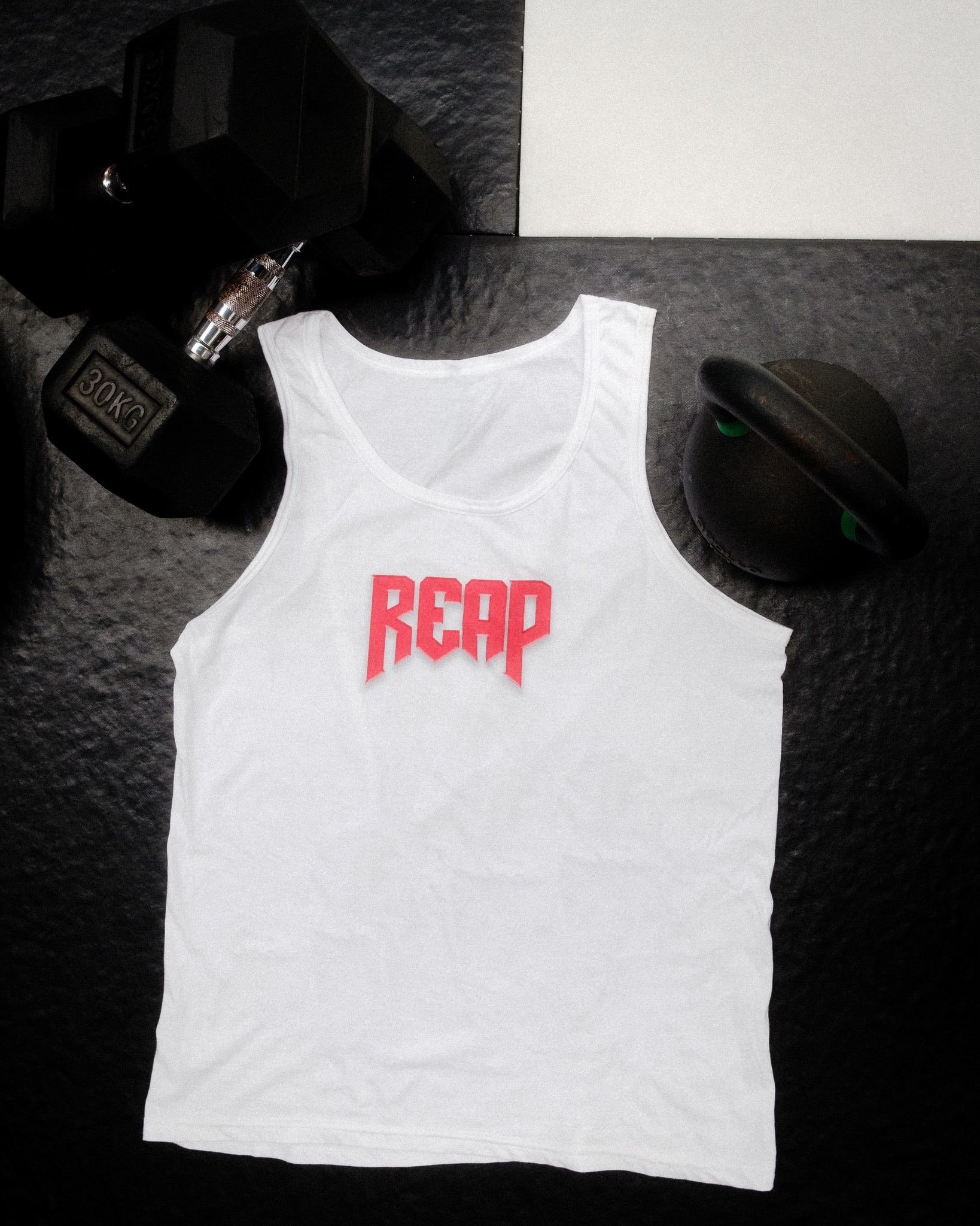White Jiu Jitsu workout vest from Reap Jiu Jitsu, featuring a sleek design for active individuals. Ideal for martial arts training and fitness activities.