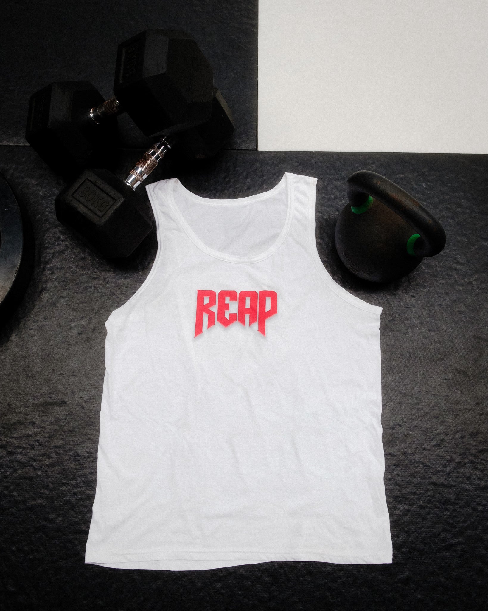White Jiu Jitsu workout vest from Reap Jiu Jitsu, featuring a sleek design for active individuals. Ideal for martial arts training and fitness activities.