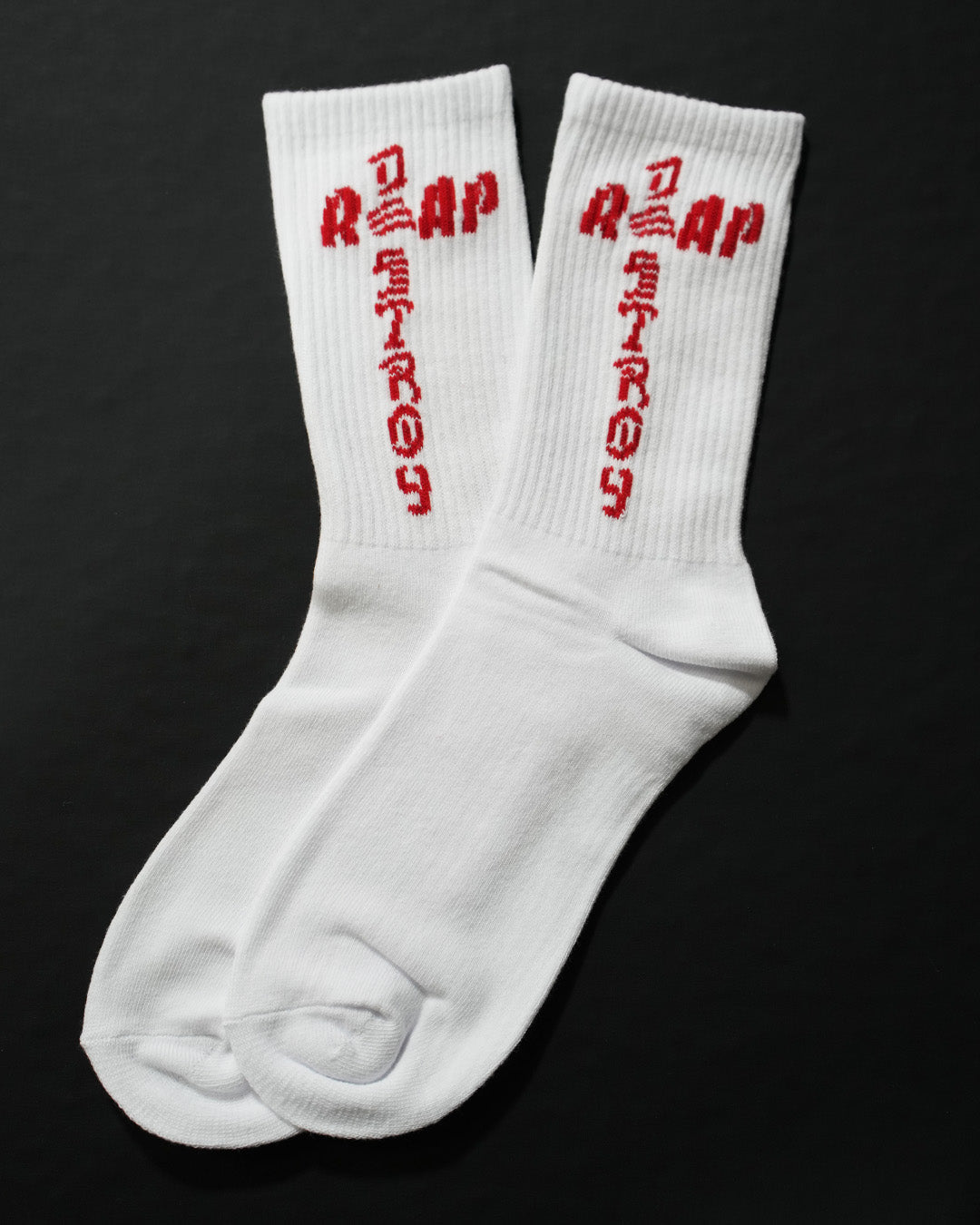 Reap and Destroy white BJJ socks with red print, flat lay view 1
