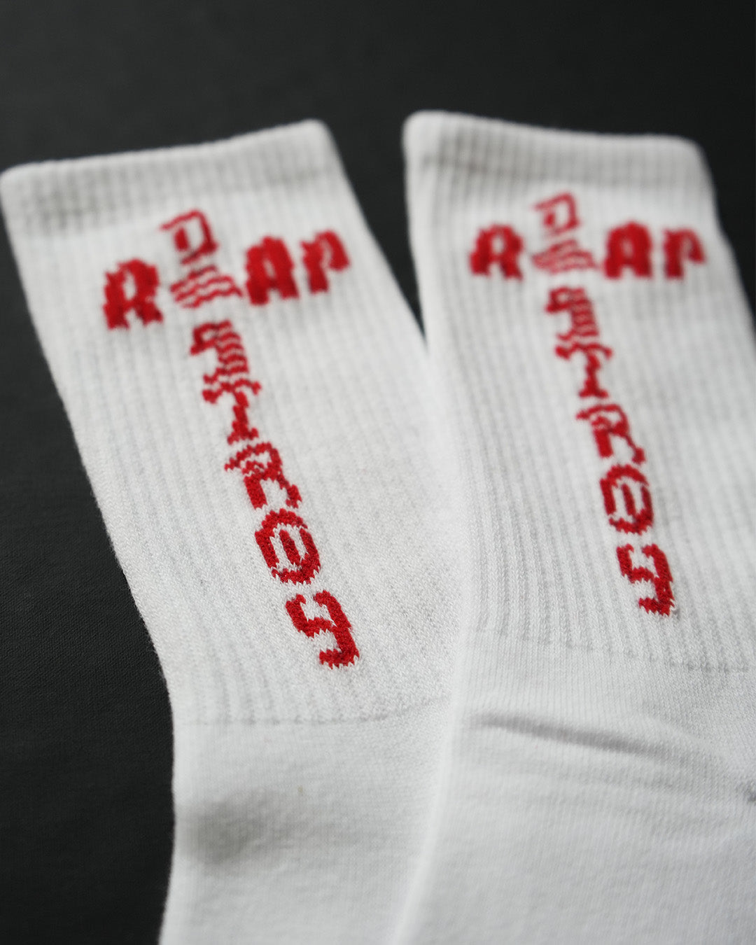 Reap and Destroy white BJJ socks with red print, flat lay view 2